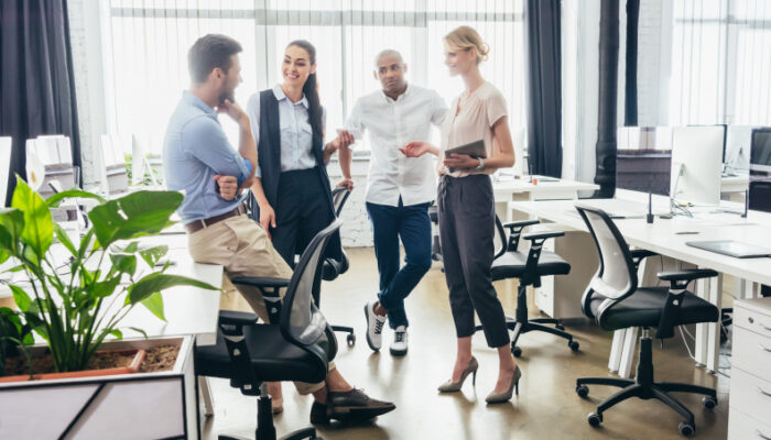 Four business colleagues talking in an office.