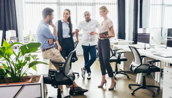 Four business colleagues talking in an office.